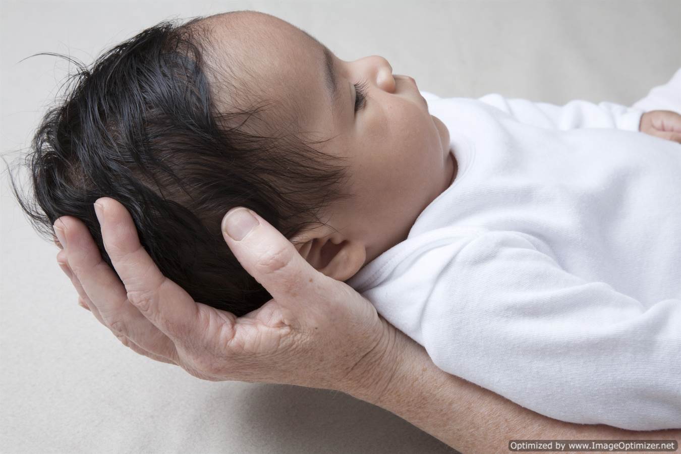 Baby receiving hands on craniosacral therapy